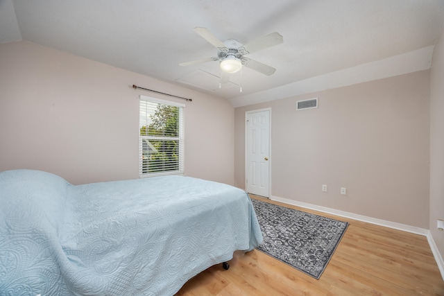 bedroom with lofted ceiling, hardwood / wood-style floors, and ceiling fan