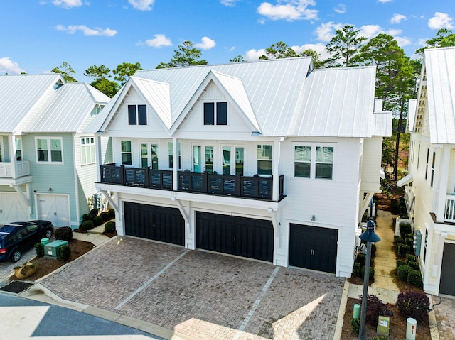 view of property with a balcony and a garage