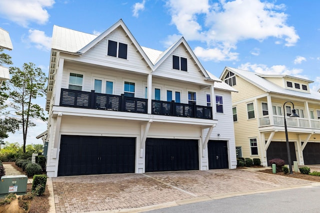 view of front facade with a balcony and a garage