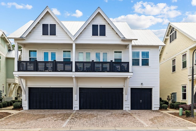 view of front of property with a balcony and a garage