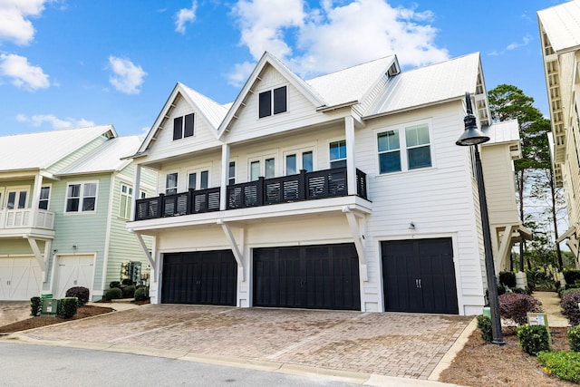 townhome / multi-family property with a balcony and a garage