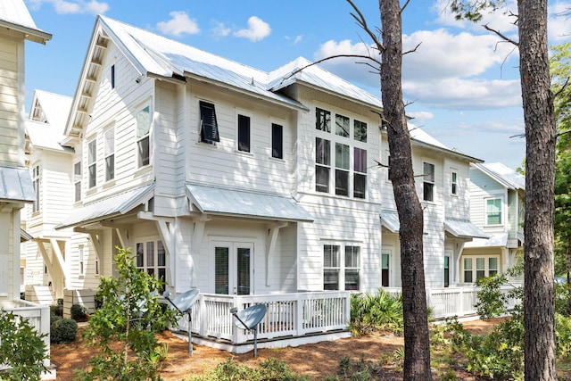 rear view of house featuring a wooden deck