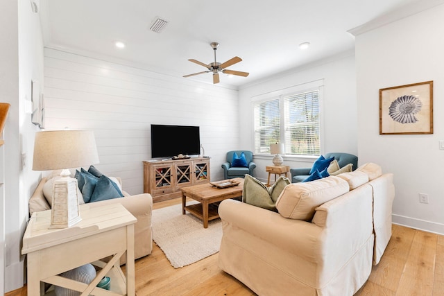 living room featuring ceiling fan, light hardwood / wood-style flooring, and ornamental molding