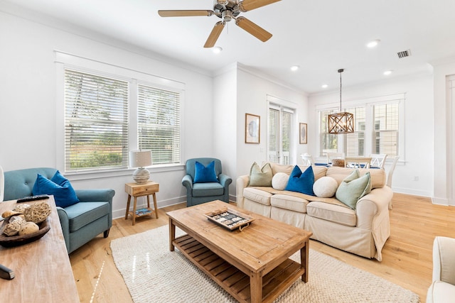 living room with ornamental molding, ceiling fan, and light hardwood / wood-style flooring