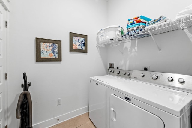 laundry room featuring light tile patterned flooring and washer and clothes dryer