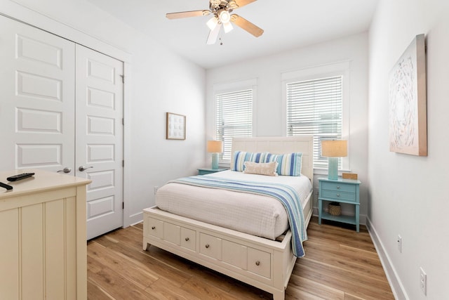 bedroom with a closet, light wood-type flooring, and ceiling fan