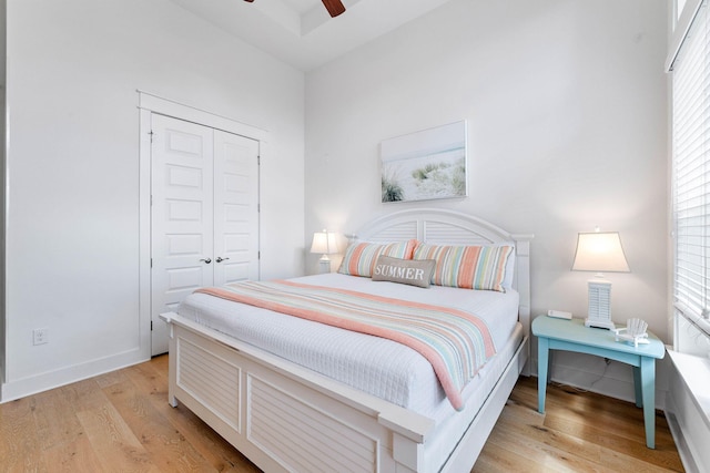 bedroom featuring ceiling fan, a closet, and light hardwood / wood-style floors