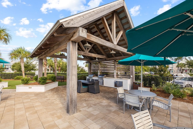 view of patio with a gazebo, a grill, and exterior kitchen