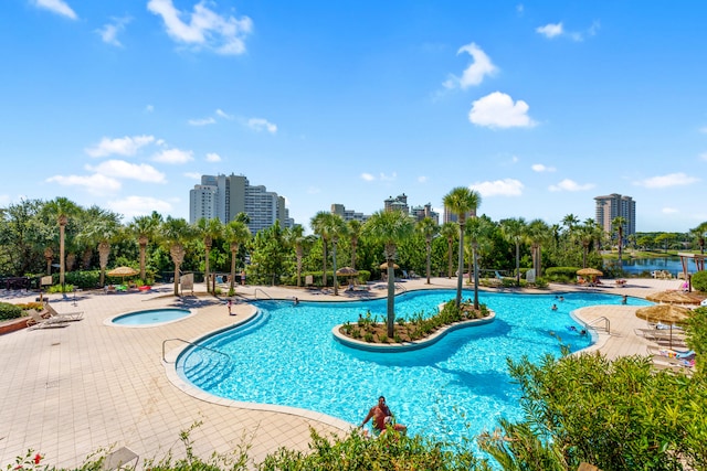 view of pool with a patio and a community hot tub