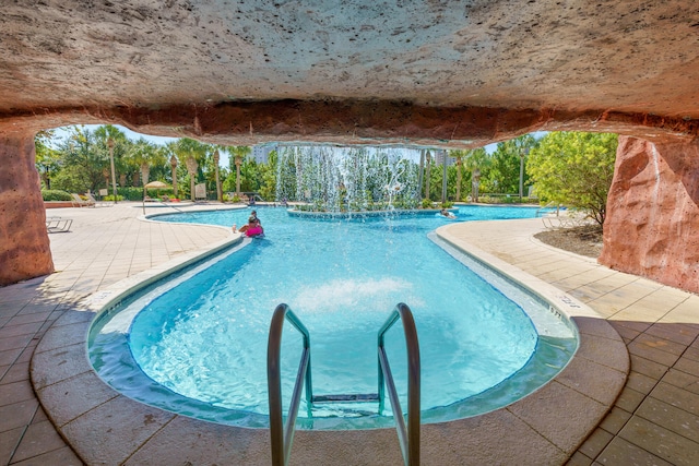 view of pool with a patio area and pool water feature