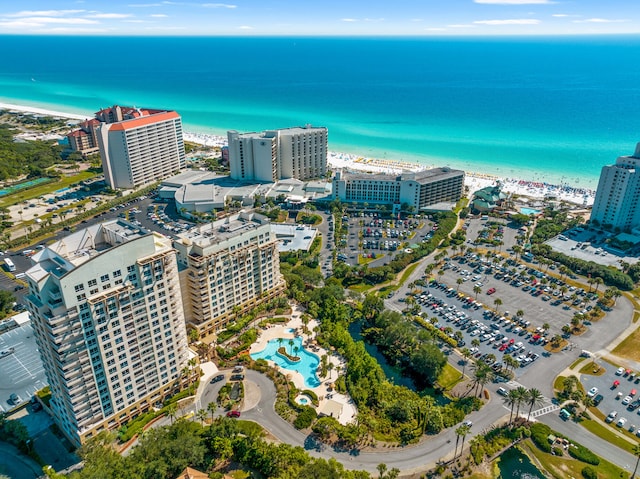 aerial view with a water view and a beach view