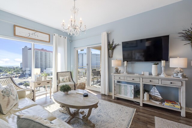 living room featuring a notable chandelier, plenty of natural light, and dark hardwood / wood-style flooring