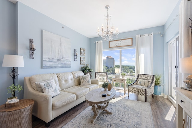 living room featuring a notable chandelier and dark hardwood / wood-style floors