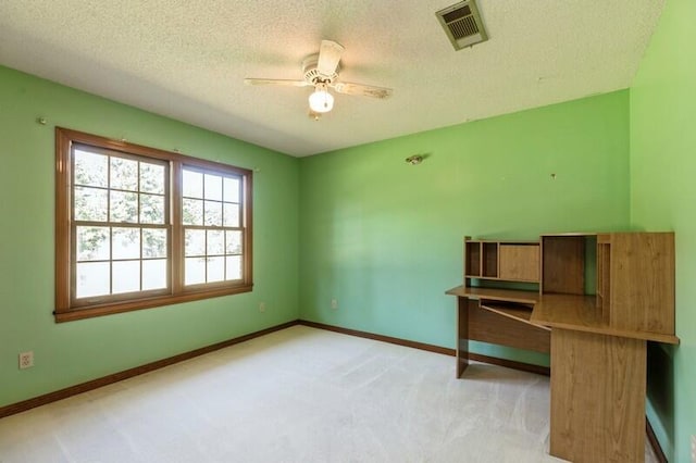 unfurnished room with light carpet, a textured ceiling, and ceiling fan