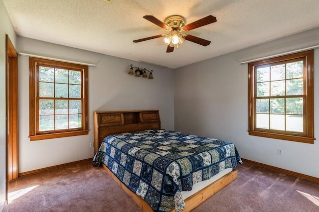 bedroom with carpet flooring, a textured ceiling, and ceiling fan