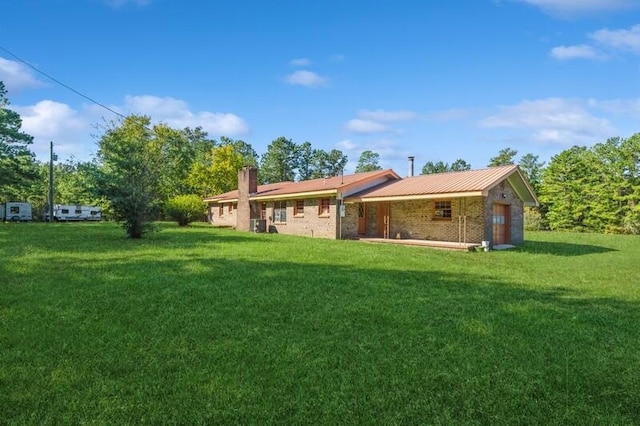 rear view of property featuring a yard