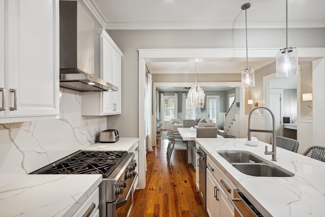 kitchen featuring white cabinetry, sink, wall chimney range hood, and stainless steel appliances