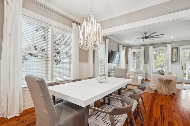 dining room with ceiling fan with notable chandelier, dark hardwood / wood-style floors, and crown molding