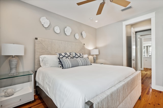 bedroom with ceiling fan and hardwood / wood-style flooring