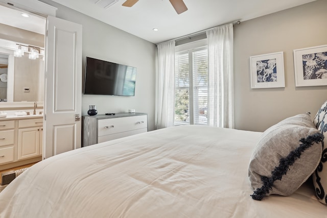 bedroom featuring ensuite bath and ceiling fan