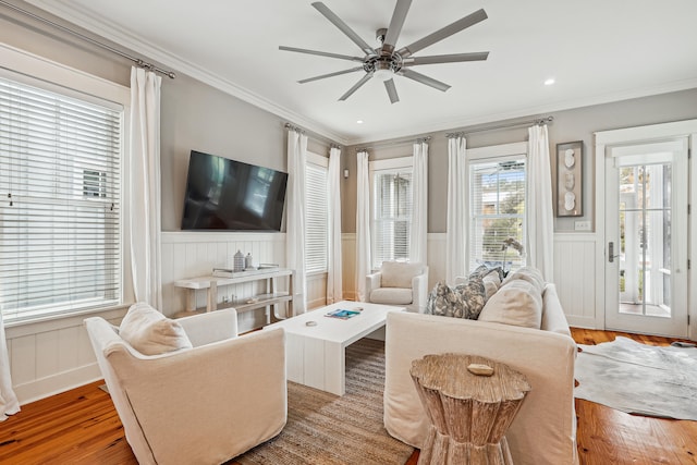 living room featuring ceiling fan, light hardwood / wood-style flooring, and crown molding