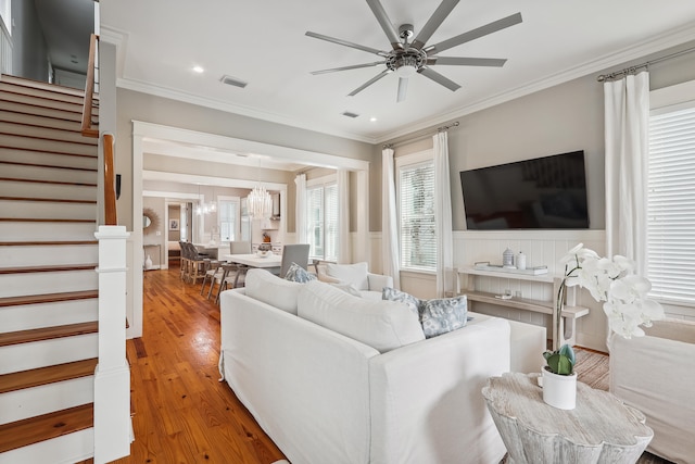 living room featuring ornamental molding, ceiling fan, and hardwood / wood-style flooring