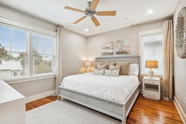 bedroom with ceiling fan and hardwood / wood-style floors