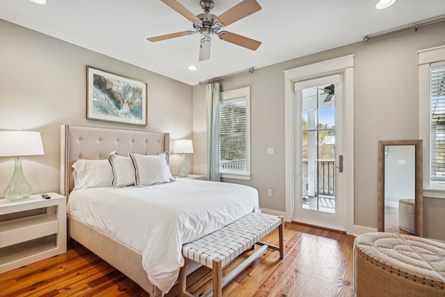 bedroom featuring access to outside, hardwood / wood-style floors, and ceiling fan