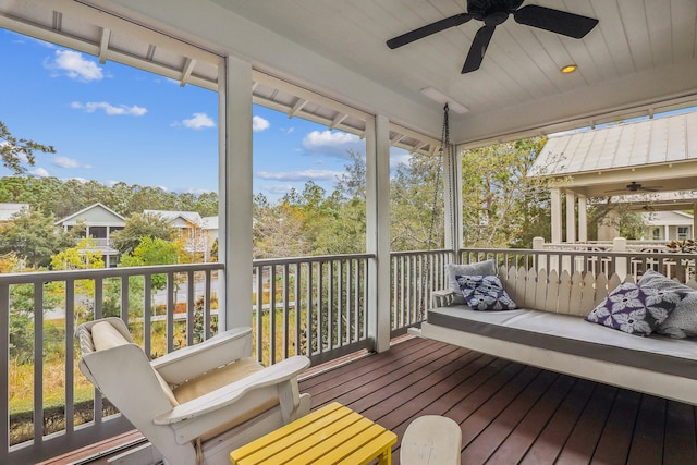 sunroom / solarium featuring a wealth of natural light and ceiling fan