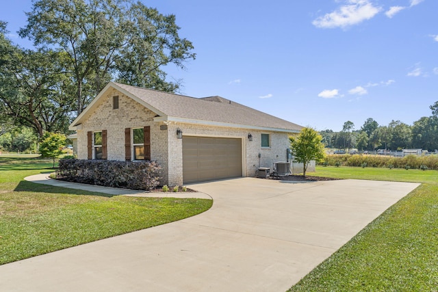 view of front of property featuring a front lawn, central AC unit, and a garage