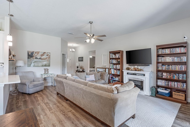 living room with hardwood / wood-style floors and ceiling fan