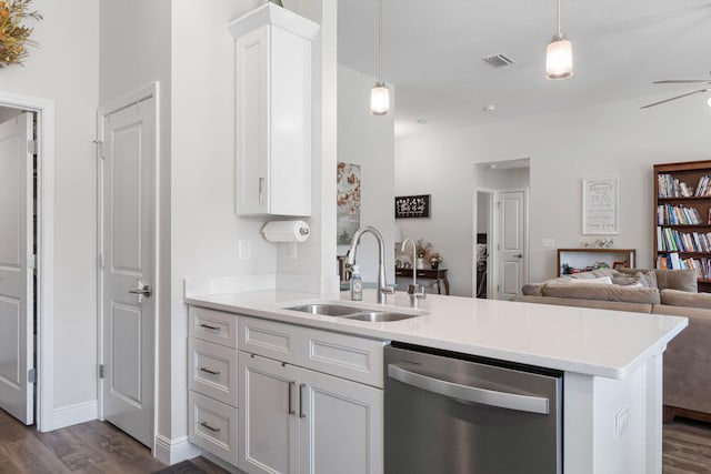 kitchen with kitchen peninsula, dishwasher, white cabinets, and sink