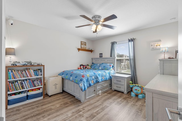 bedroom with light wood-type flooring and ceiling fan