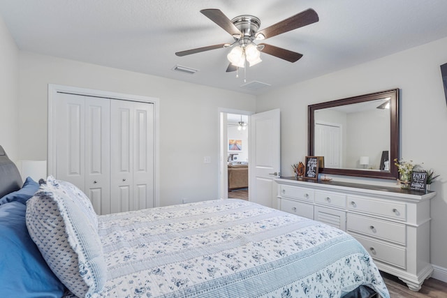 bedroom with a closet, ceiling fan, and hardwood / wood-style floors