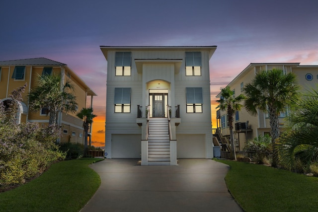 view of front of home with a lawn and a garage