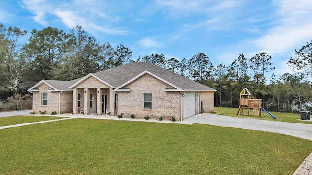 view of front of house featuring a front yard, a playground, and a garage