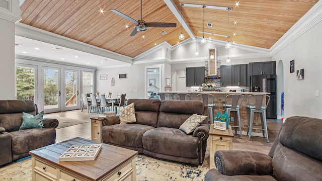 living room with wood ceiling, vaulted ceiling, ceiling fan, and light hardwood / wood-style floors