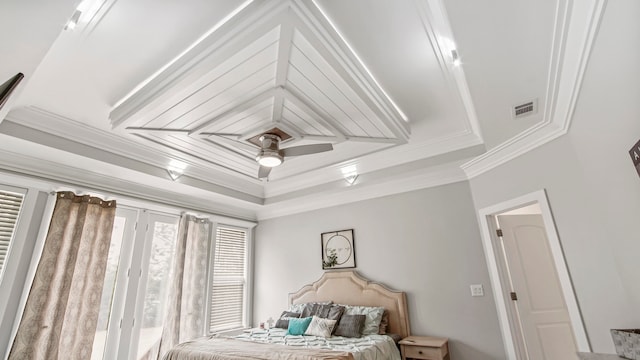 bedroom with a tray ceiling, ceiling fan, and crown molding