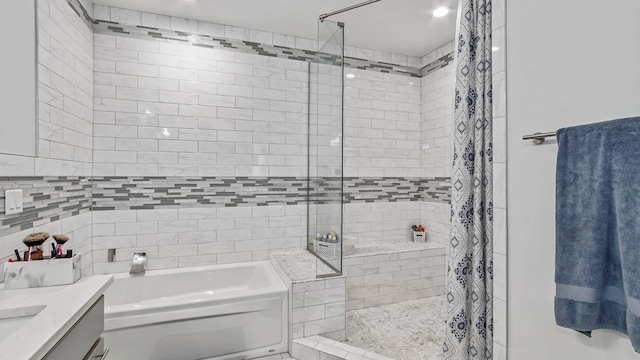 bathroom featuring independent shower and bath and vanity