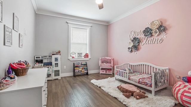 bedroom featuring ceiling fan, a crib, crown molding, and dark hardwood / wood-style flooring