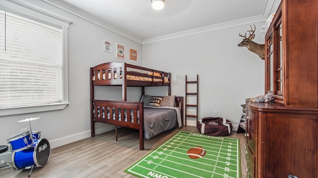 bedroom featuring light wood-type flooring and crown molding