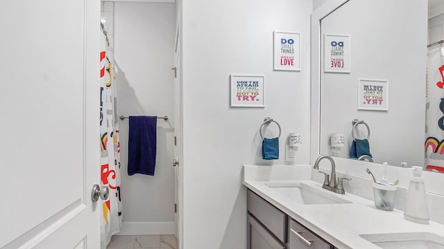 bathroom featuring vanity and curtained shower