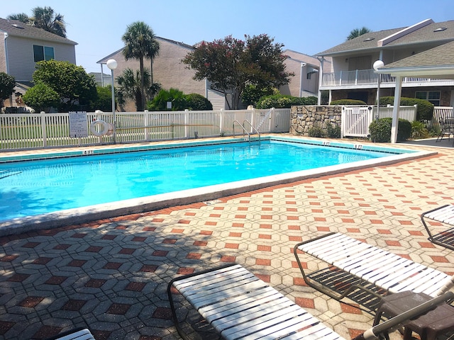 view of swimming pool featuring a patio area