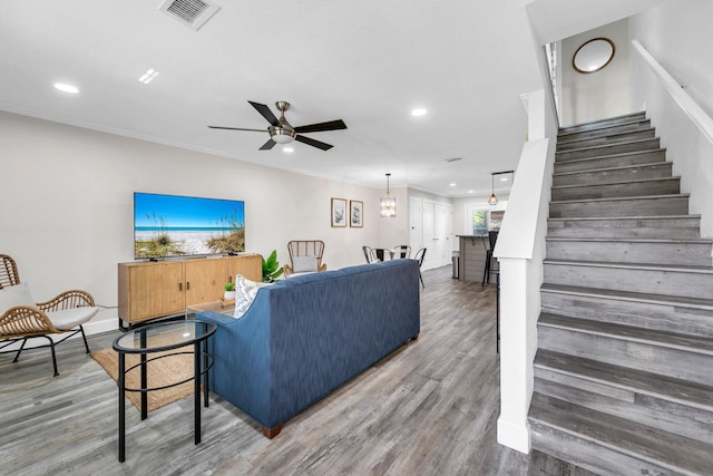 living room with ceiling fan, crown molding, and hardwood / wood-style floors