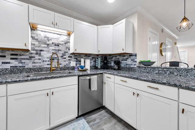 kitchen with dark stone counters, sink, white cabinetry, crown molding, and stainless steel dishwasher