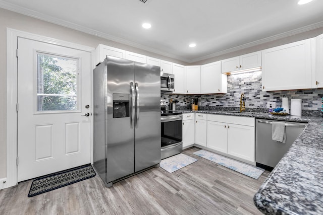 kitchen featuring white cabinets, light hardwood / wood-style floors, and appliances with stainless steel finishes