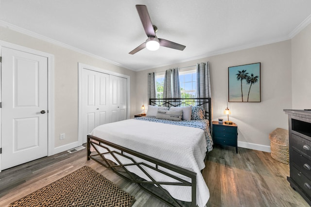 bedroom featuring ceiling fan, ornamental molding, and dark hardwood / wood-style flooring