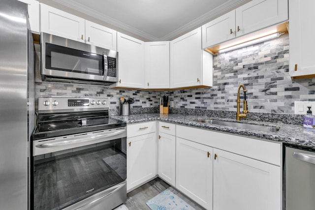 kitchen with crown molding, white cabinetry, sink, and stainless steel appliances