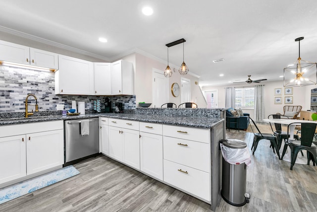 kitchen featuring white cabinetry, decorative light fixtures, and stainless steel dishwasher