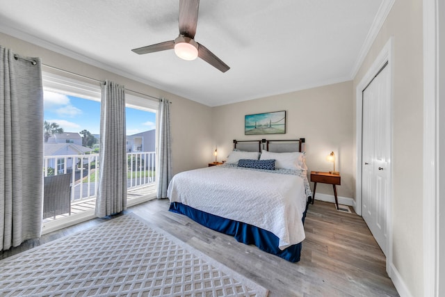 bedroom featuring access to outside, hardwood / wood-style flooring, a closet, and ceiling fan